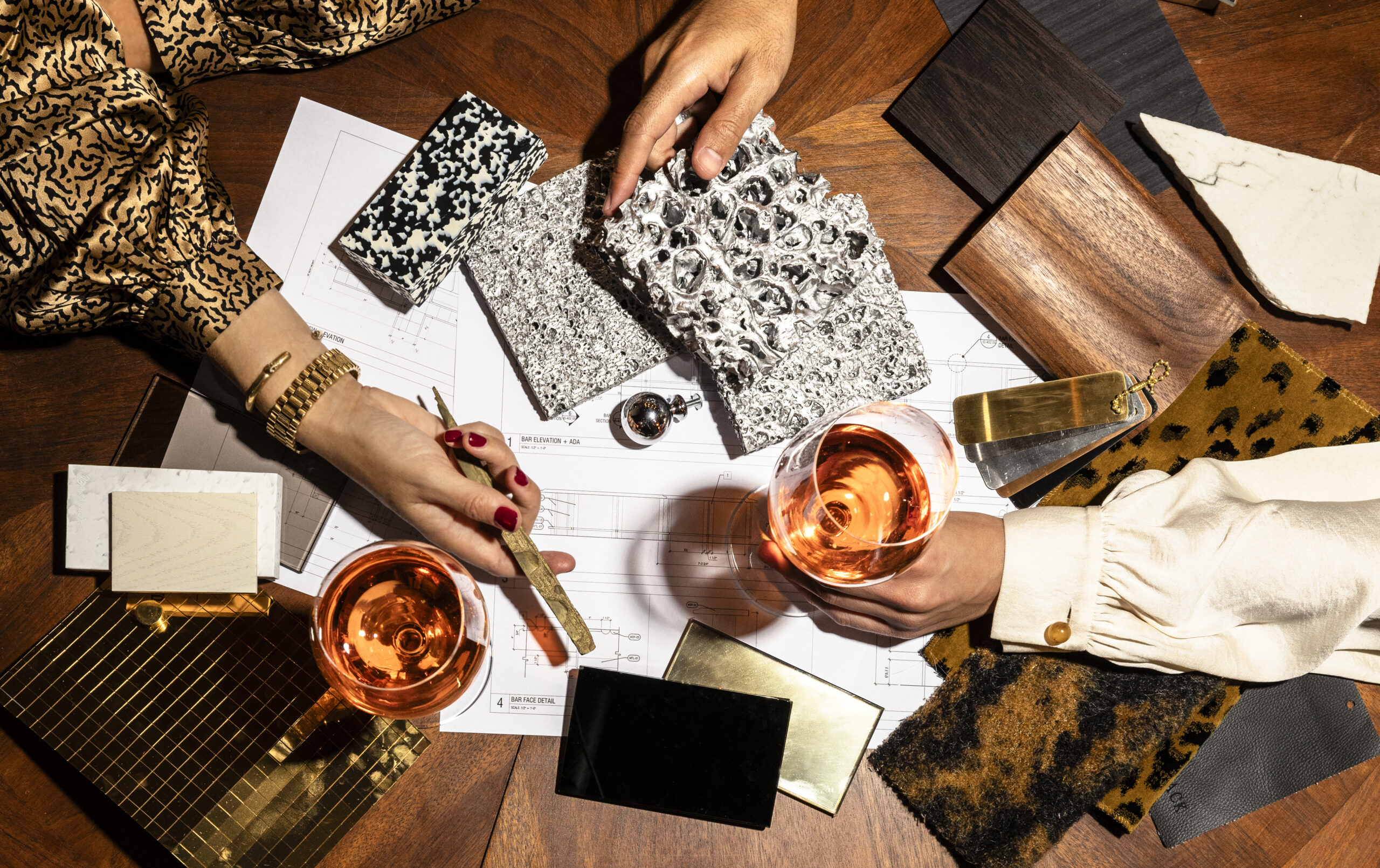 An interior design meeting, where designers are reviewing and selecting various material and finish samples for an architectural project.