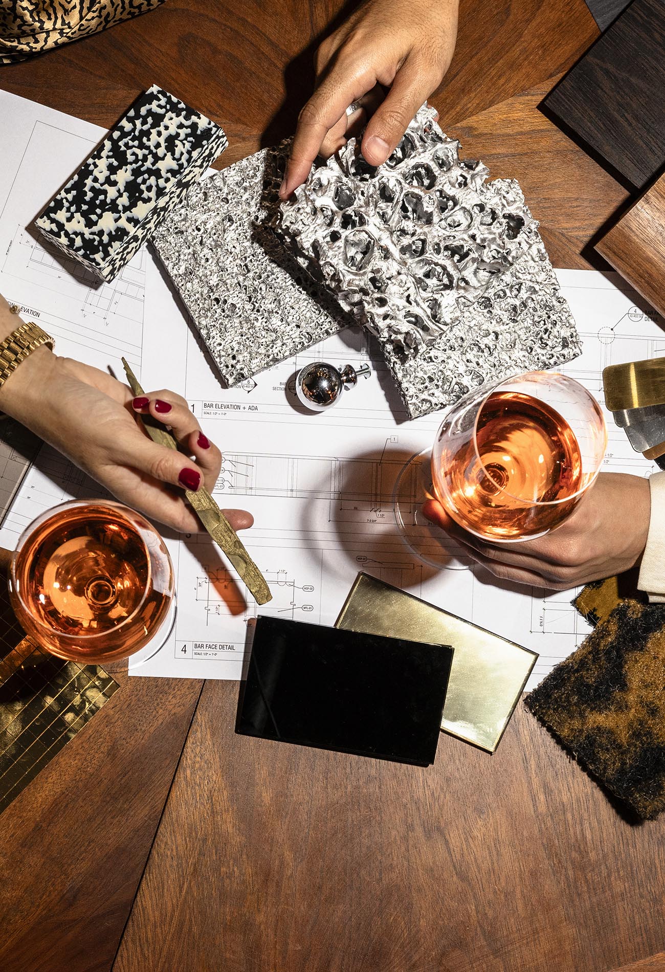 An interior design meeting, where designers are reviewing and selecting various material and finish samples for an architectural project.