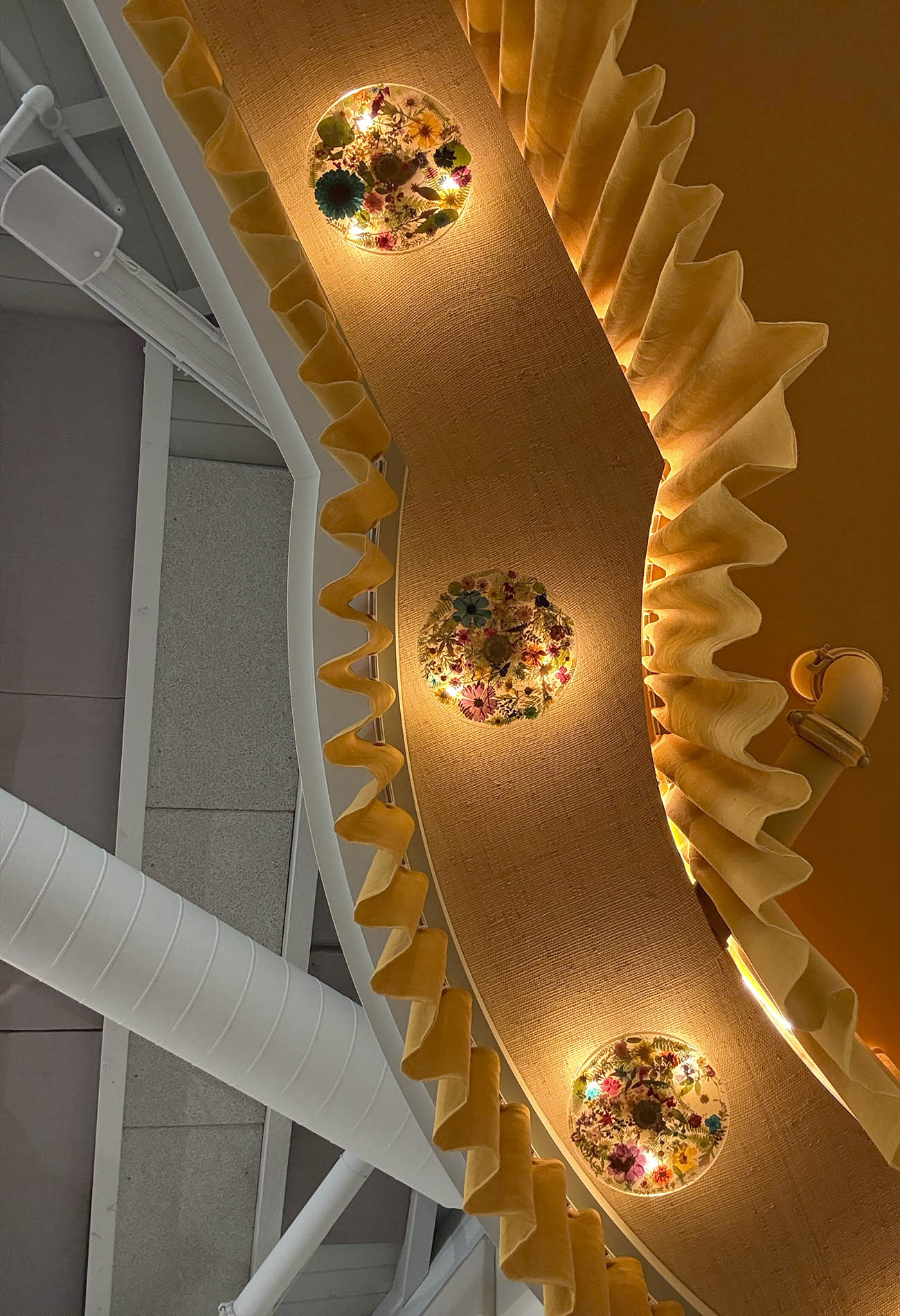 Custom lights with flowers installed in the bar area of the restaurant Lana in Solana Beach, California. The interior design was created by Workind Studio.